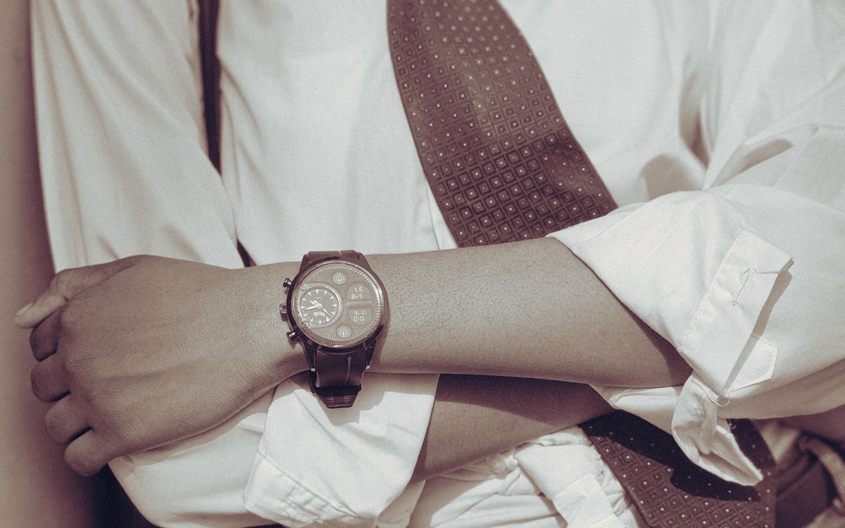 Stylish business attire with a watch and a bag laid out on a chair
