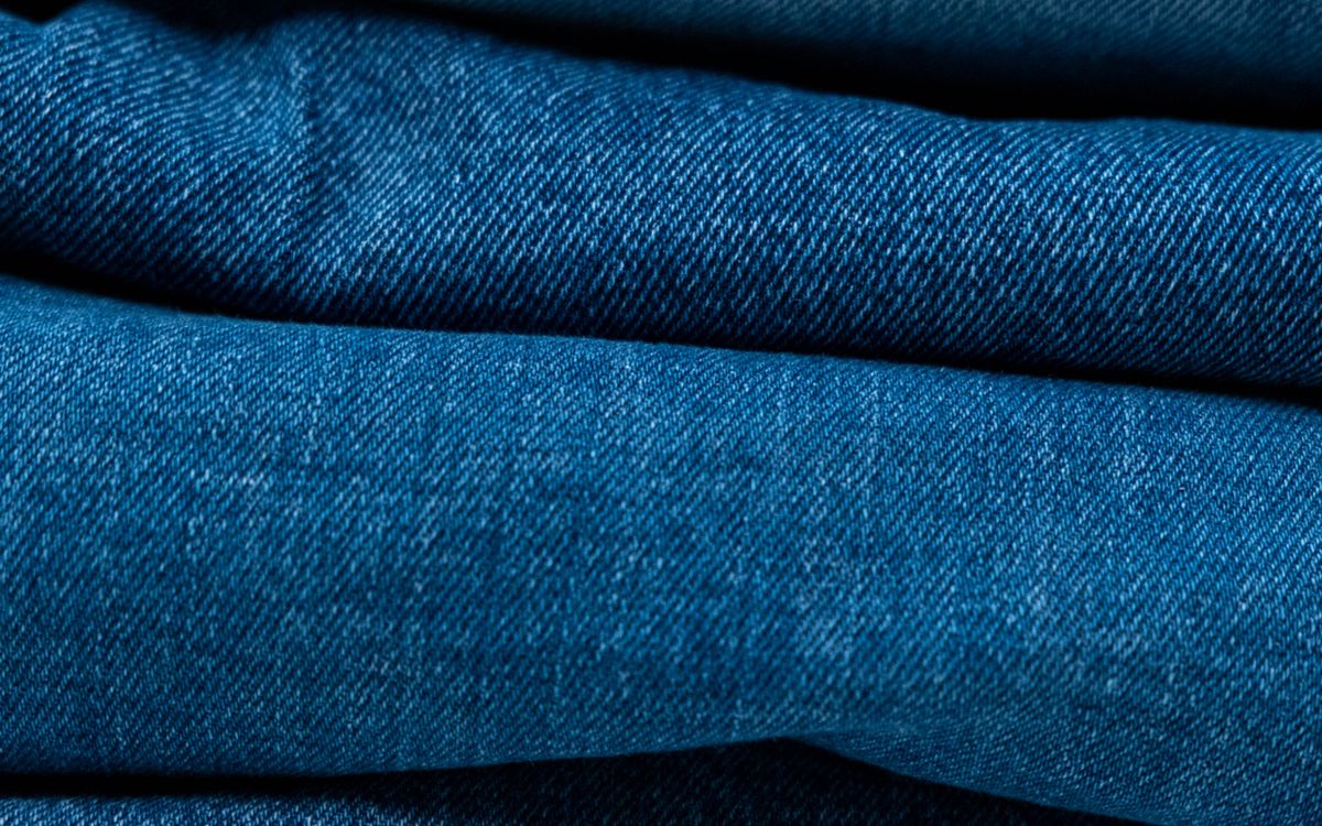 A stack of folded denim pants