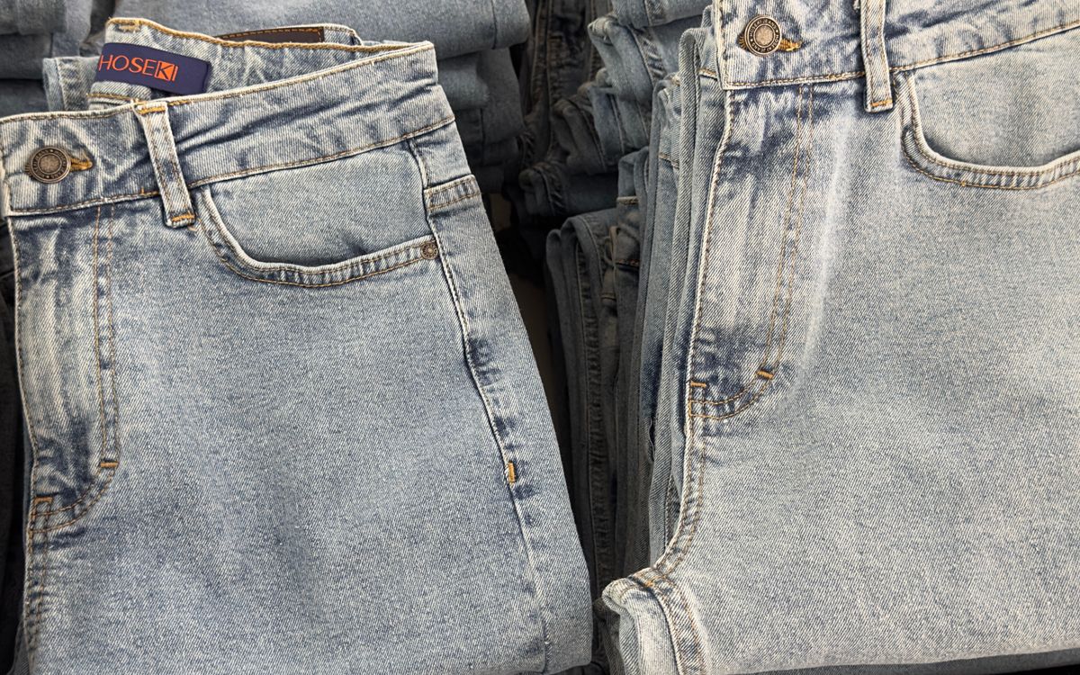 Pairs of jeans displayed on shelves in a clothing store