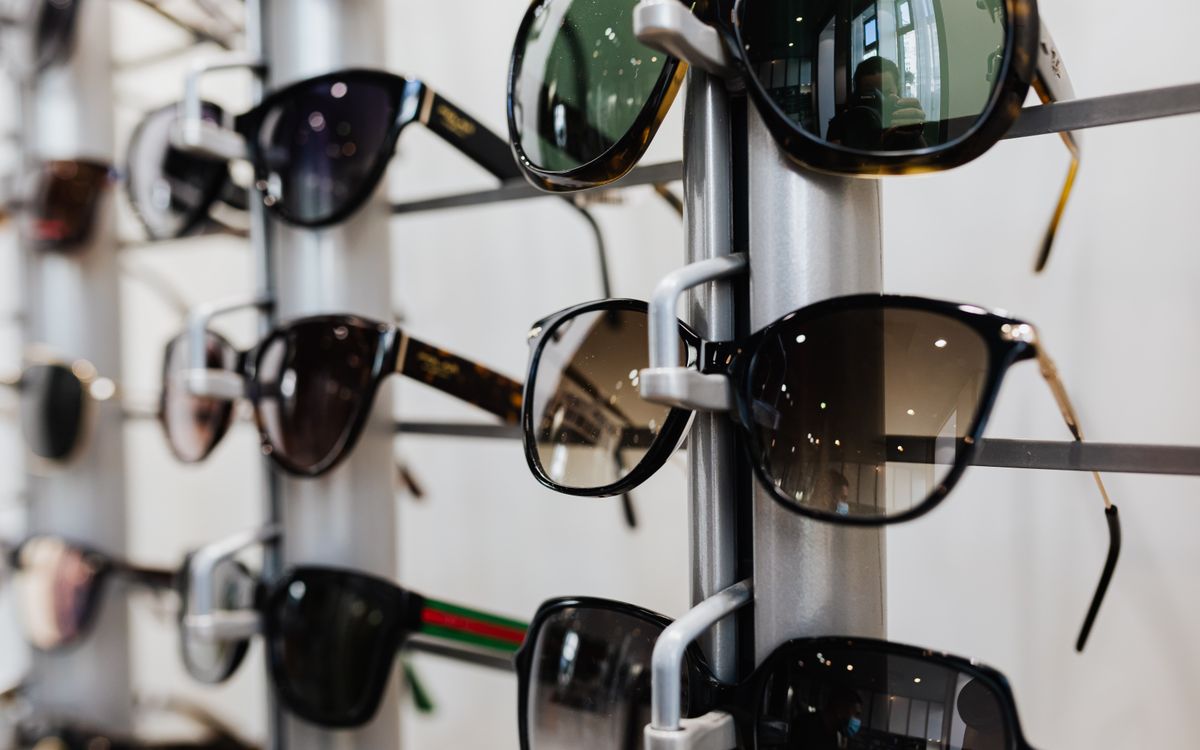 A rack of sunglasses on display, dark frames and tinted lenses catching the light